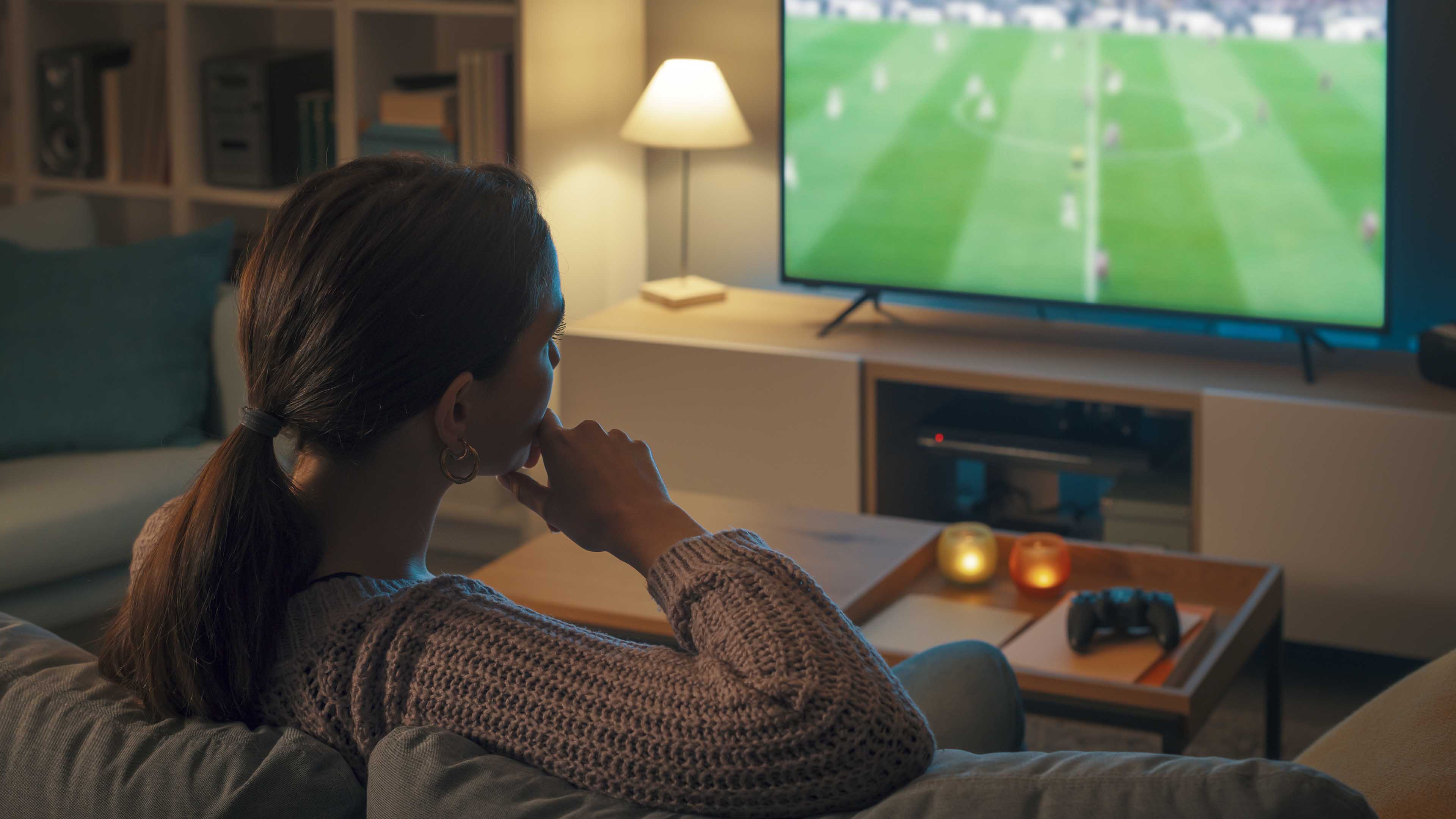 Kvinde Der Sidder I Sofaen Og Ser Fodbold På Tv